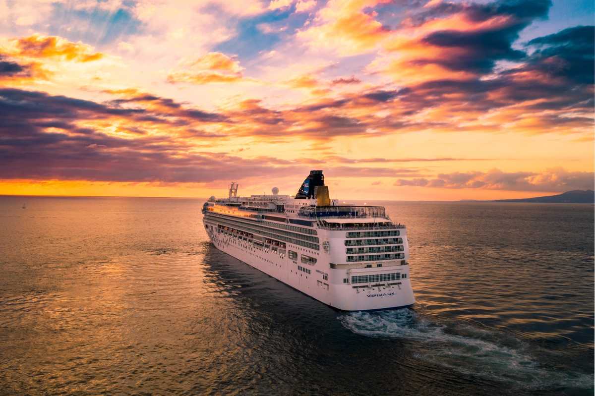 Cruise ship sailing into the sunset during Wave Season