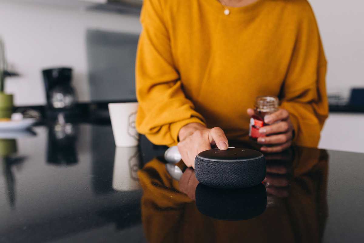 Woman with Bluetooth speaker.